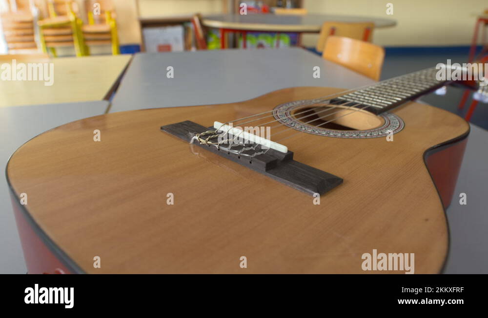 Acoustic guitar in young childrens school classroom music lesson Stock
