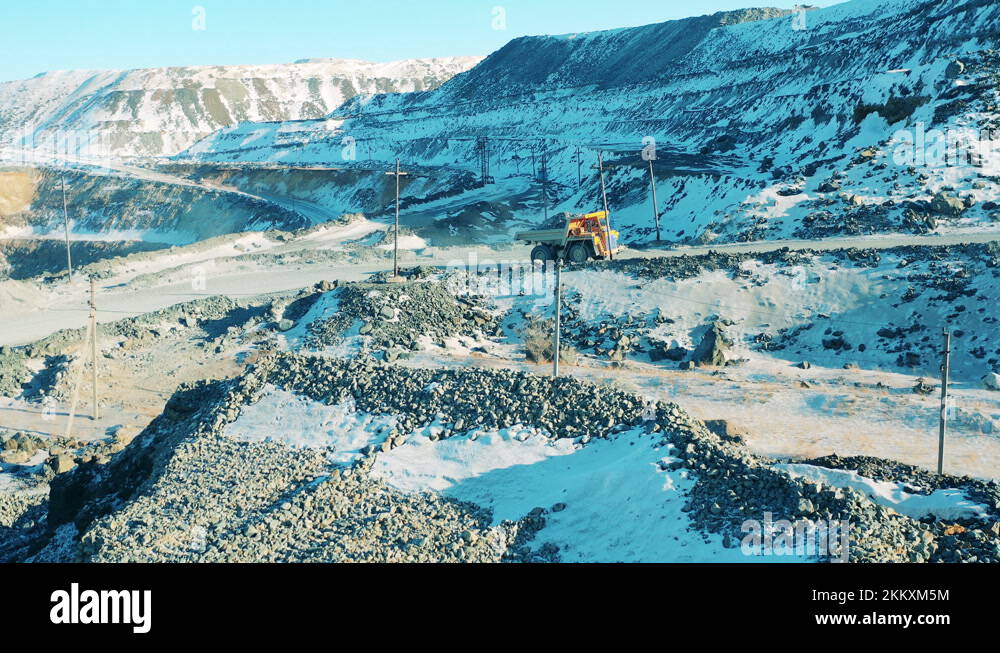 Quarry Riding Truck loaded with ore is riding along the mine site. Industrial quarry ...