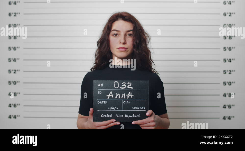 Mugshot Of Millennial Arrested Woman With Curly Hair Being Photographed   Mugshot Of Millennial Arrested Woman With Curly Hair Being Photographed In 2kkxxt2 