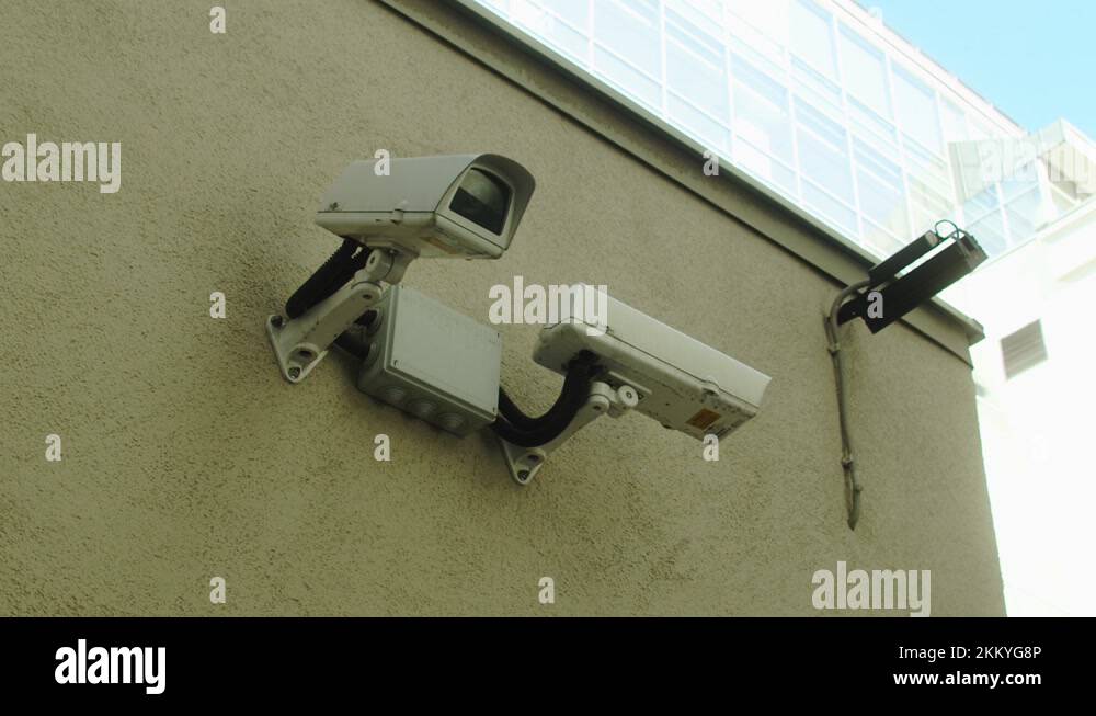 Security video camera moving to scan the area for surveillance purposes