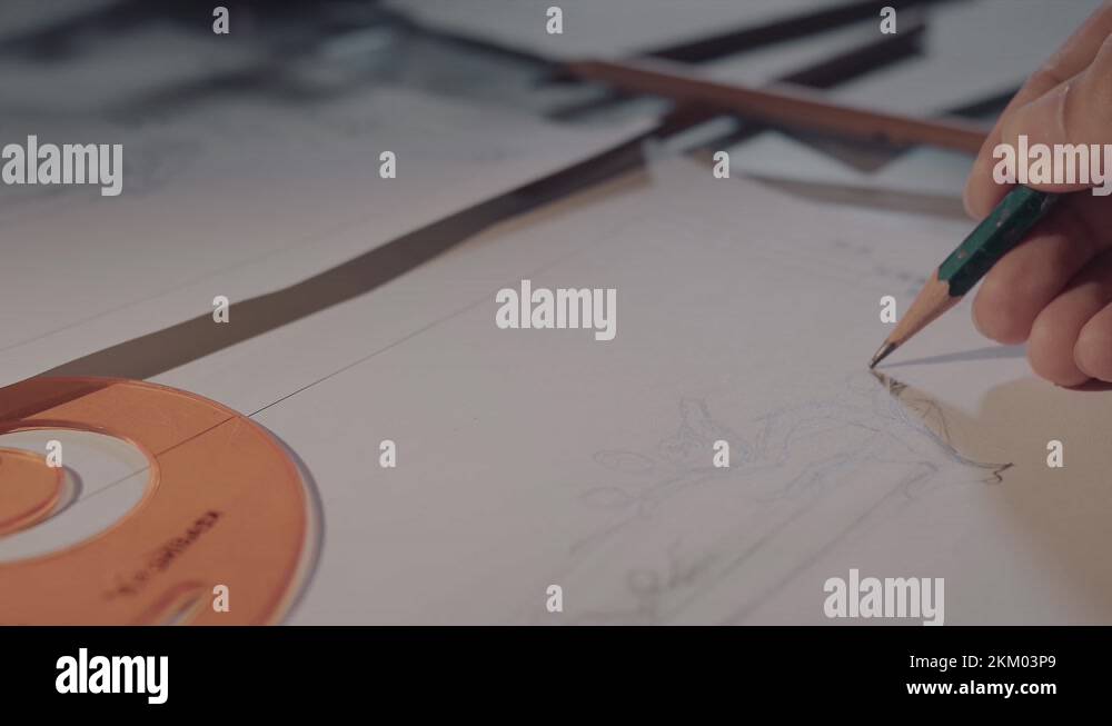 Drawings, tape measure, ruler and other drawing tools on artist desk ...