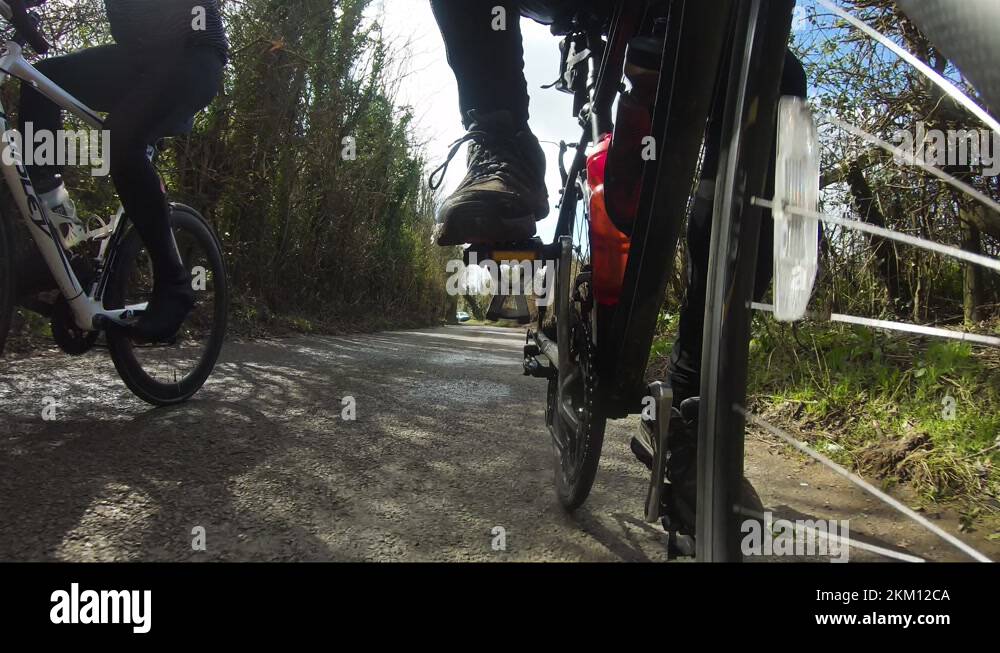 Low Angle POV Of Cyclist Leg Spinning Crank On Bike. Follow Shot Stock