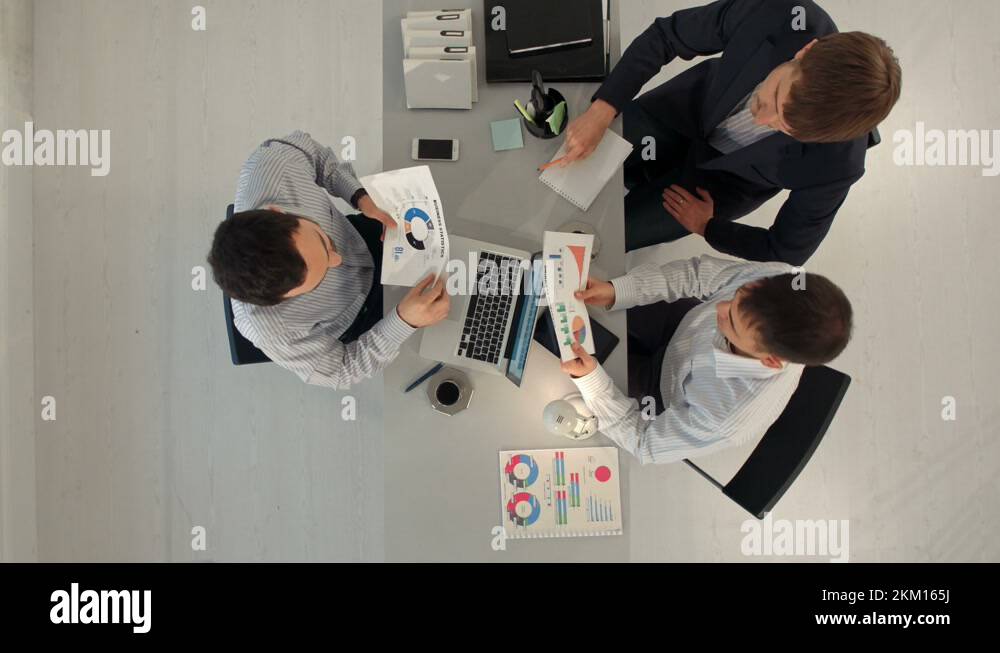 Creative team displaying charts with laptop and tablet pc computers ...