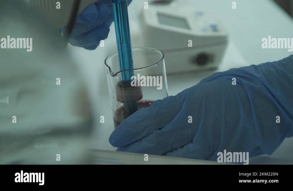 Laboratory working process. Testing natural juice made of fruit Stock