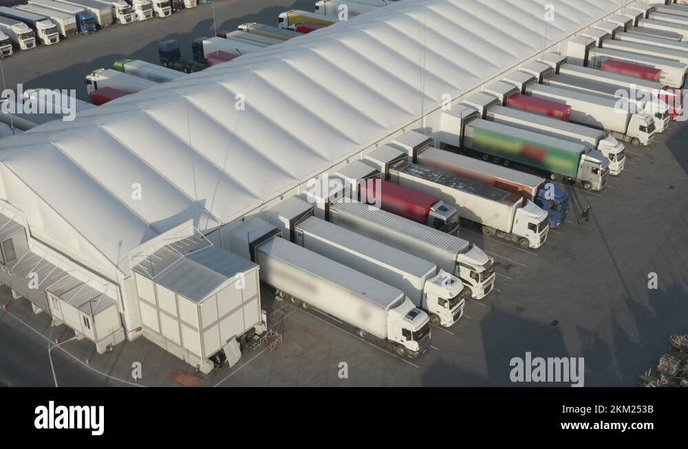Semitrailers trucks stand at warehouse ramps for load and unload goods
