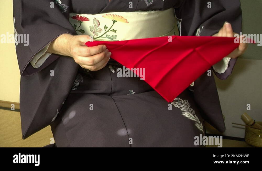 A tea master folds a fukusa tea cloth during a Japanese tea ceremony