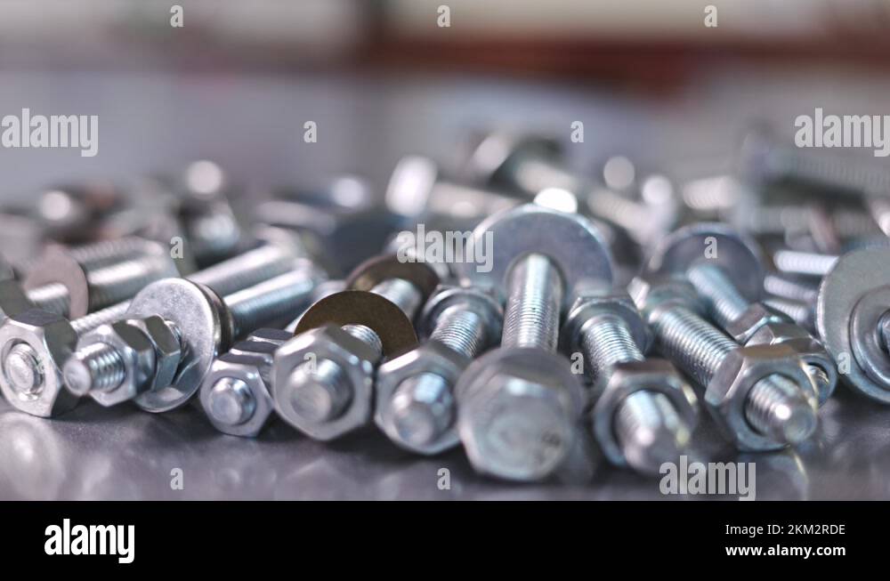 Slider shot video of chrome bolts and nuts in a chaotic order