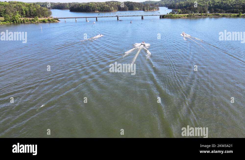 Three boats approaching a no wake zone on local lake. No wake zone