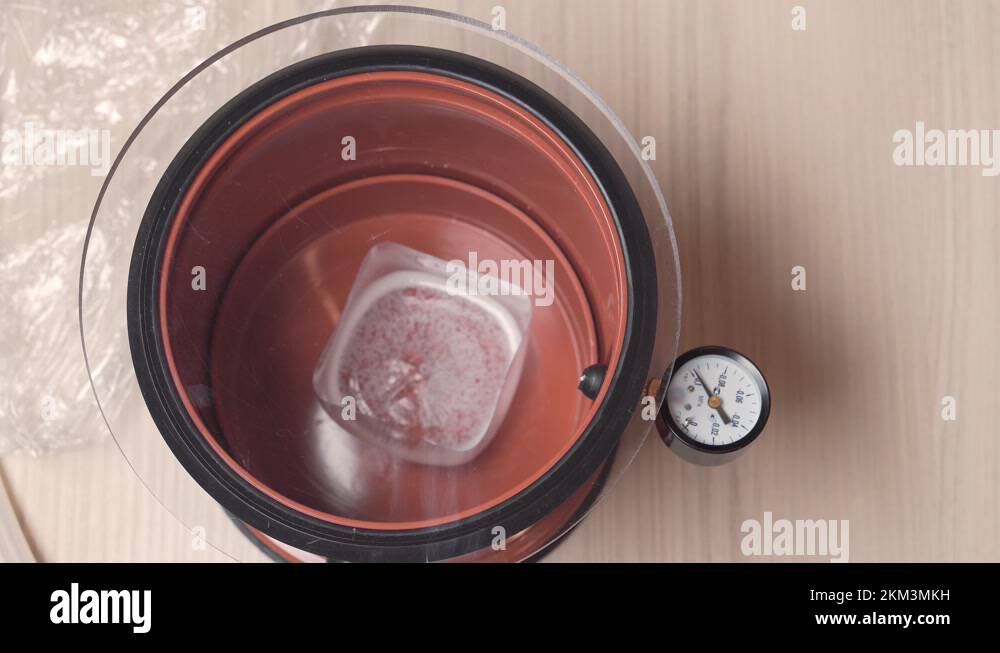 The process of vacuum degassing of liquid. Epoxy resin in a vacuum