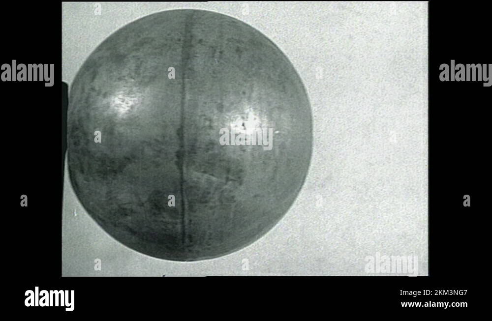 1940s: Aerial shots of facility. Close up pan of metal spheres. Hand ...