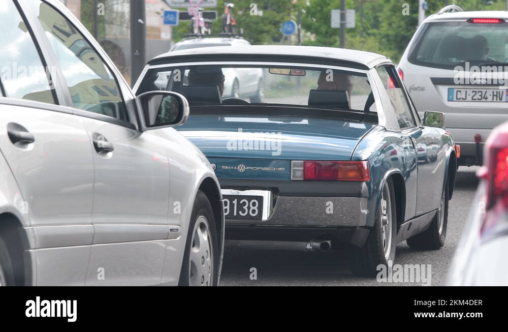 Traffic jam in French city with ultrarare vintage Porsche 914 sports