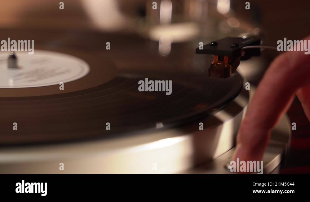 turntable with a spinning record. the finger presses the button and the head Stock Video Footage