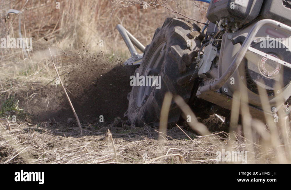 Rototiller working on a farm, agriculture in Sweden, slow motion close