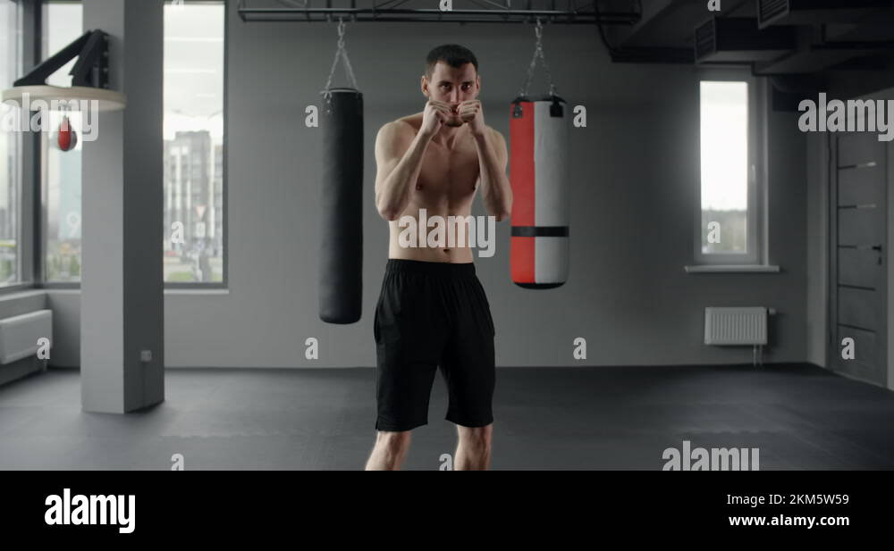 Mixed martial art fighter does shadow boxing to the camera with fast