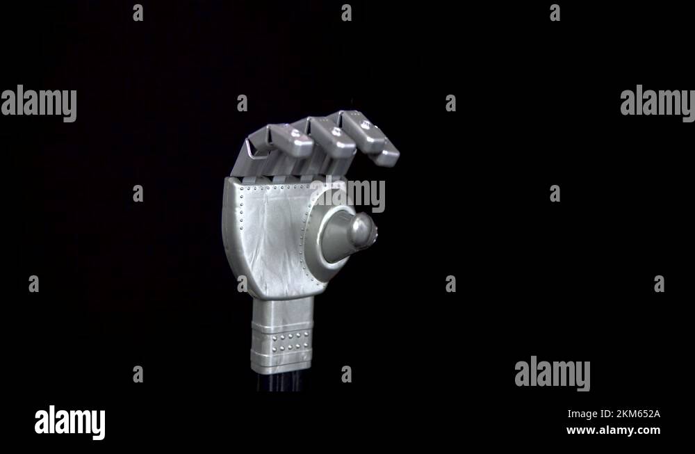 A mechanical arm flexes fingers. Gray arm came to life and began