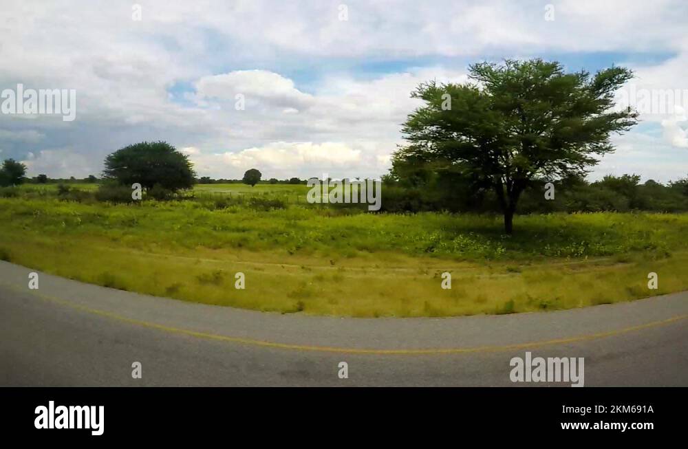 Rural landscape in the mid of Botswana filmed out of car side window ...