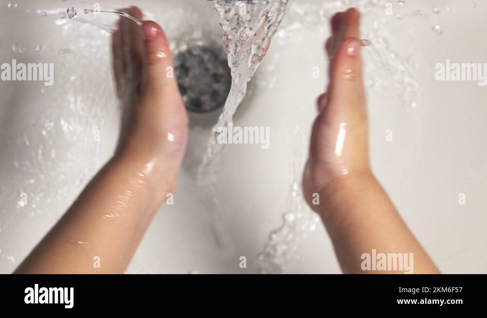Cute little girl washing her hands with a hand wash gel in sink Stock ...