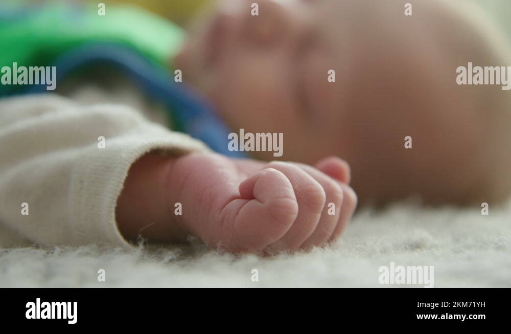 The hand of a newborn baby moves and spreads fingers while sleeping, close Stock Video Footage