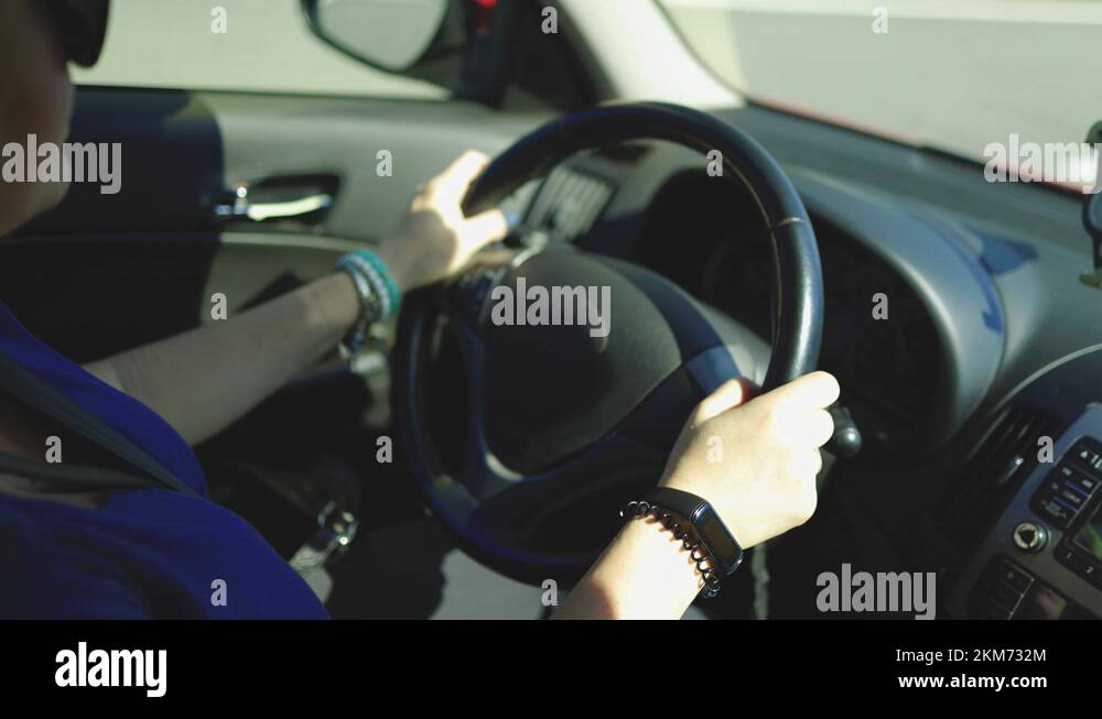 woman hands drive a car, fingers lie on the steering wheel Stock Video