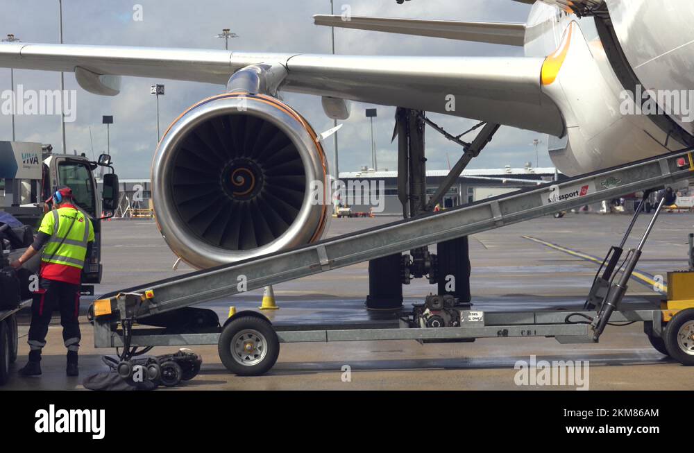 Video footage of airport baggage handler ramp agent loading the