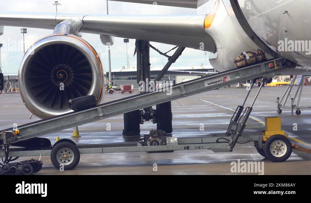 Video footage of airport baggage handler ramp agent loading the