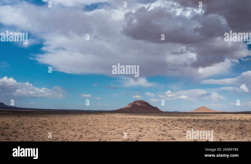Two dormant or extinct volcanoes tower over the Mojave Desert basin in