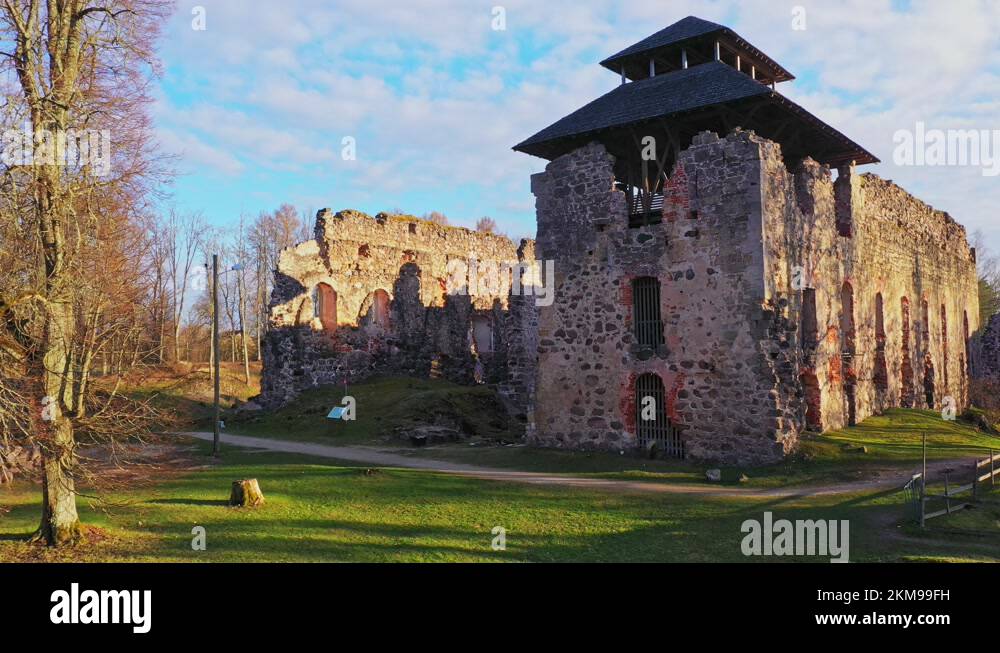 Dolly out shot revealing nature surrounding Rauna Castle in Latvia at ...
