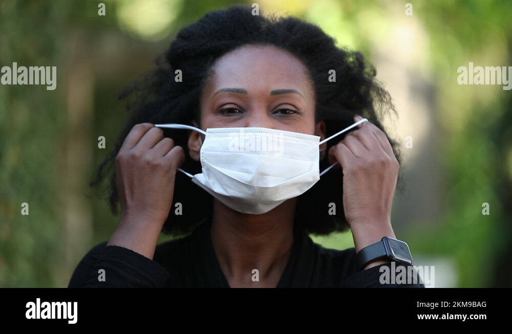 Black Woman Removing Face Mask Feeling Relief. African Woman Taking Off 