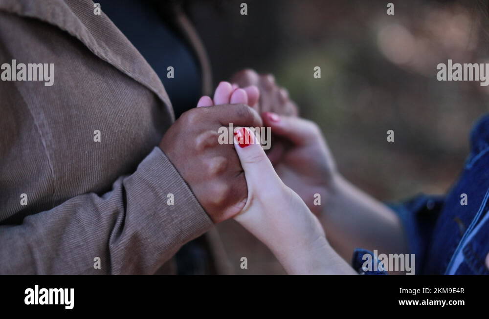 Two diverse women holding hands in support Stock Video Footage Alamy