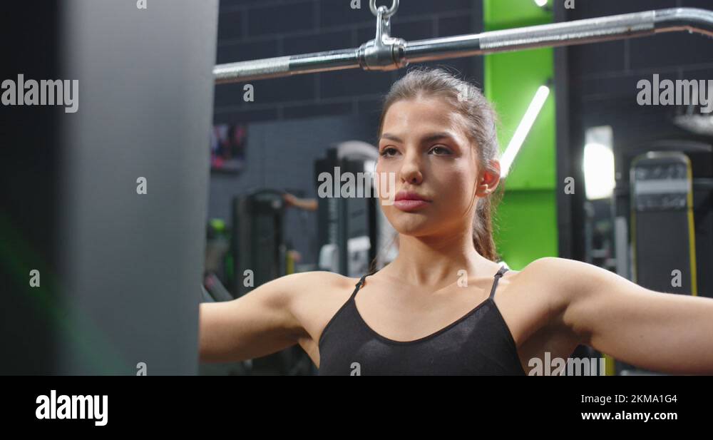 Hidden camera view of the young strong woman trainer training exercise