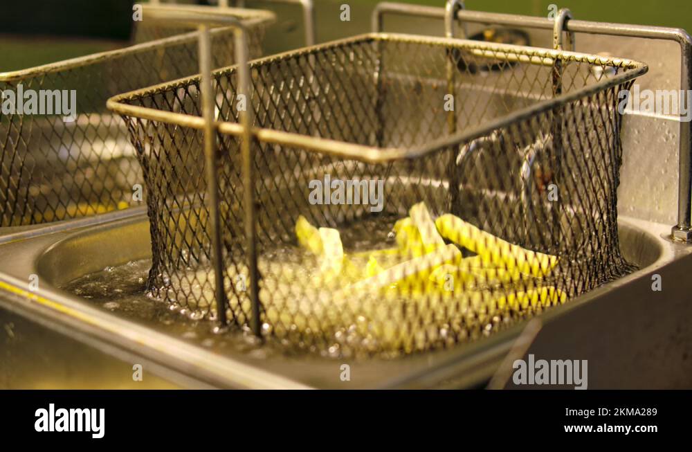 French fries in the deep fryer, in a fast food restaurant. Fries frying