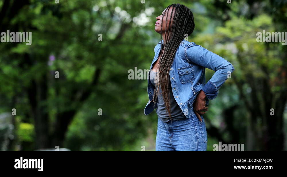 Woman adjusting pants and jacket. girl pulling pants up Stock Video