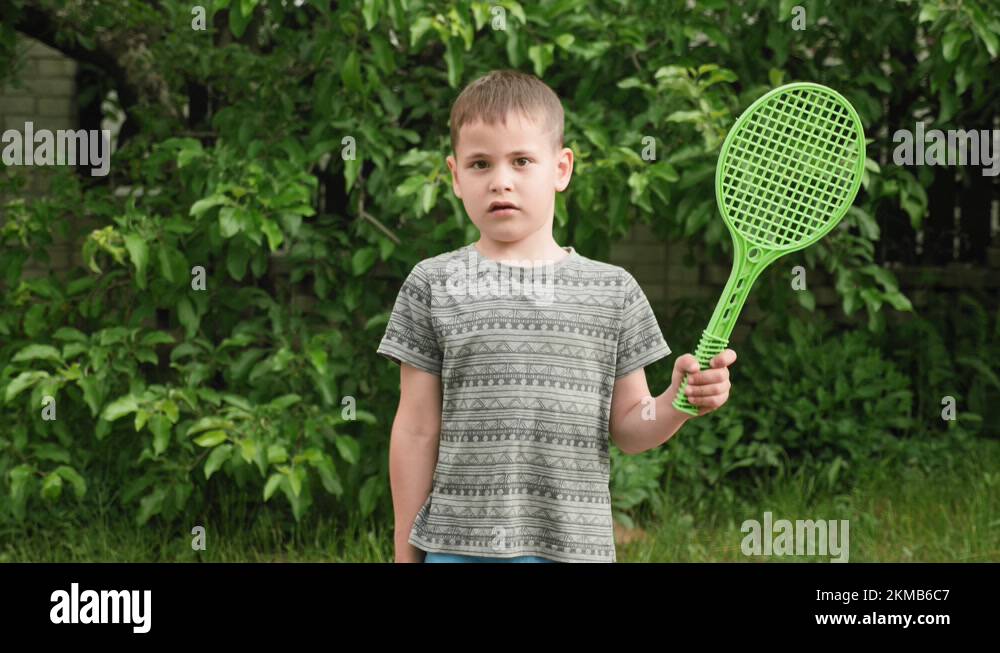 Portrait cute little smiling boy child with racket and ball. Summer ...
