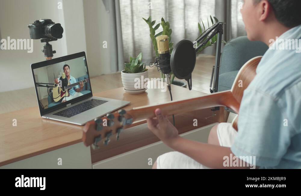 Boy Playing Guitar And Sing A Song While Streaming On Computer Laptop Stock Video Footage Alamy