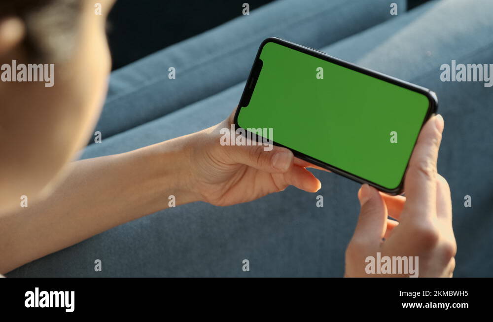 Handheld Camera Back View of Woman Holding Chroma Key Green