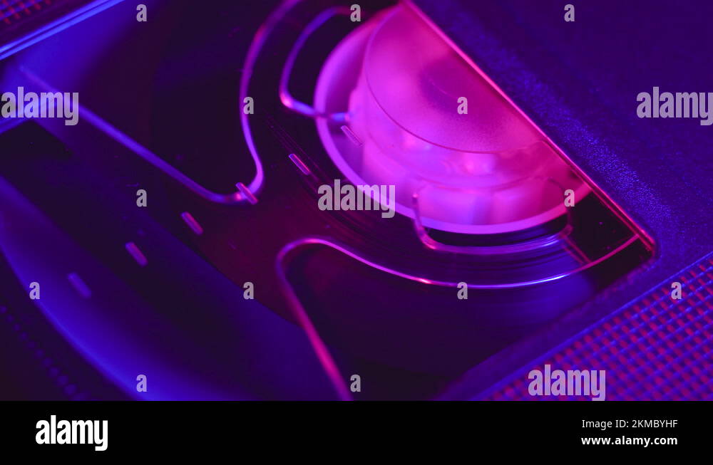 VHS cassette insert in VCR, play, stop, eject, close up, blue and purple light Stock Video