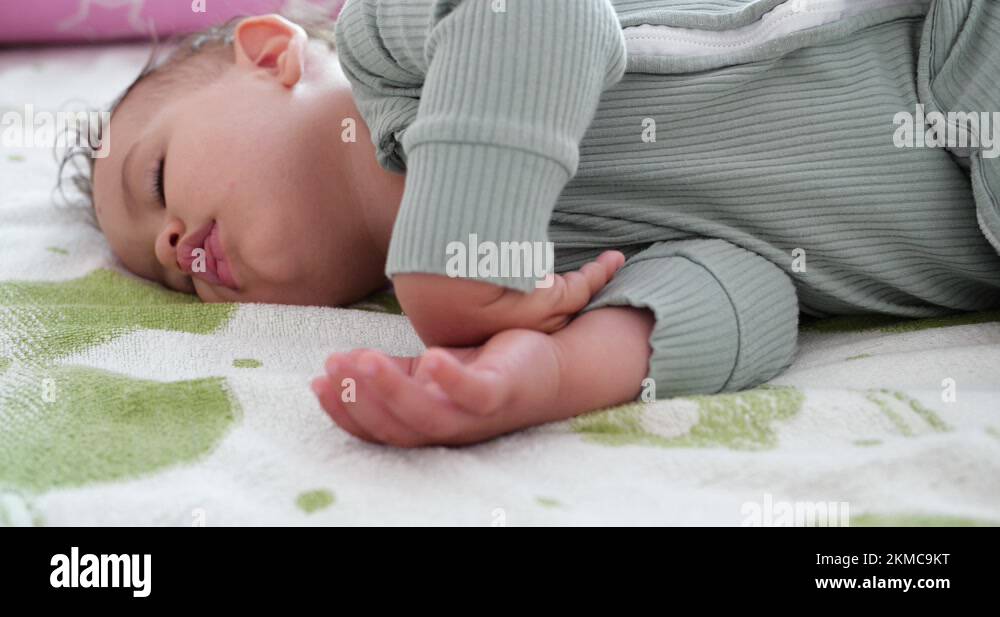 Sleeping cute baby boy on bed. Peaceful baby son sleeping on bed in a