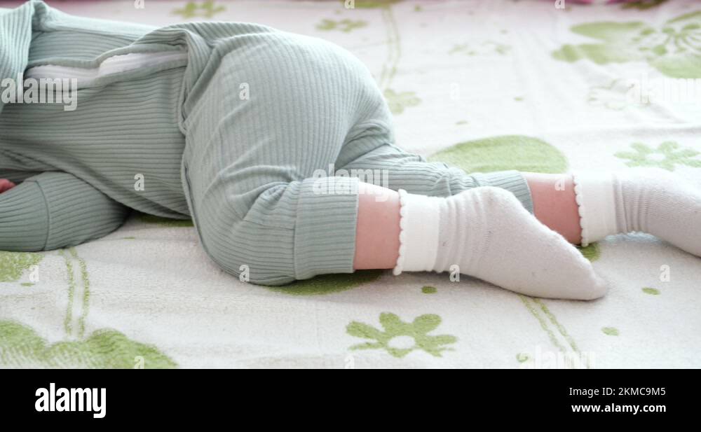 Sleeping cute baby boy on bed. Peaceful baby son sleeping on bed in a