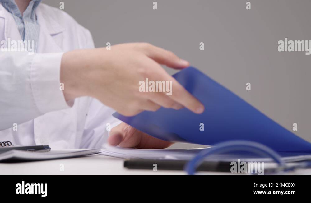 Pedestal Shot Revealing Medical Professional Going Through Documents at