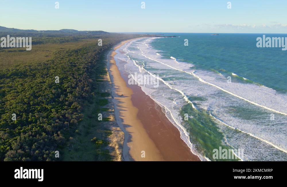 White Foamy Waves Rolling On Sandy Shore of Moonee Beach Along Moonee