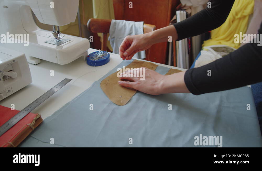 Female Dressmaker Pinning Sewing Pattern to Fabric Stock Video Footage