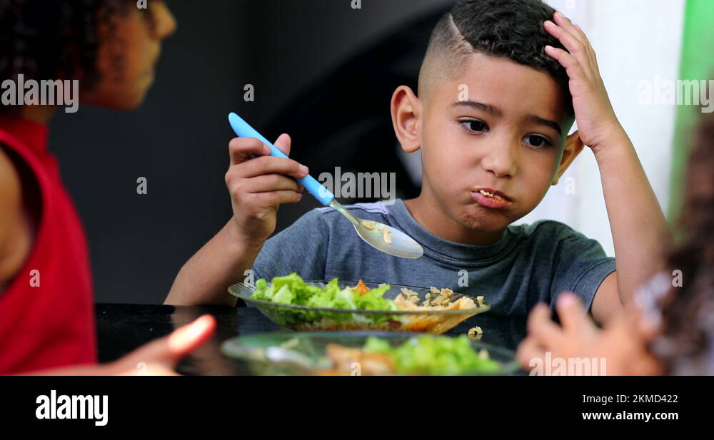 Little mixed race child eating food. Hispanic kids lunch time Stock ...
