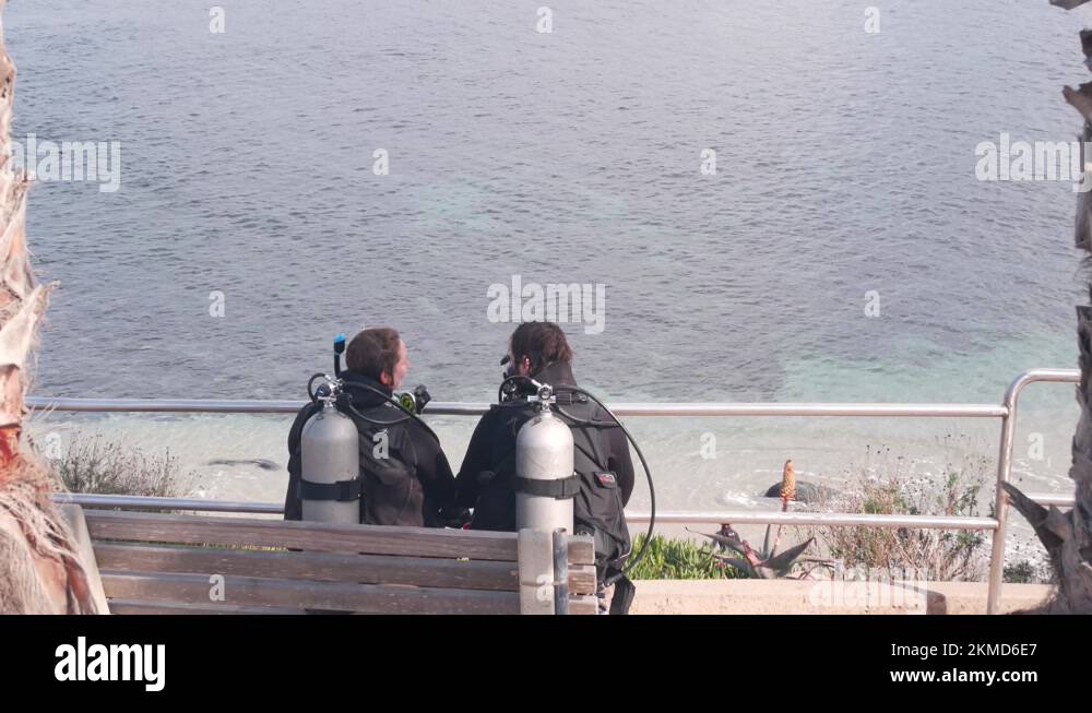 Scuba divers in suits. People after diving in cold ocean water