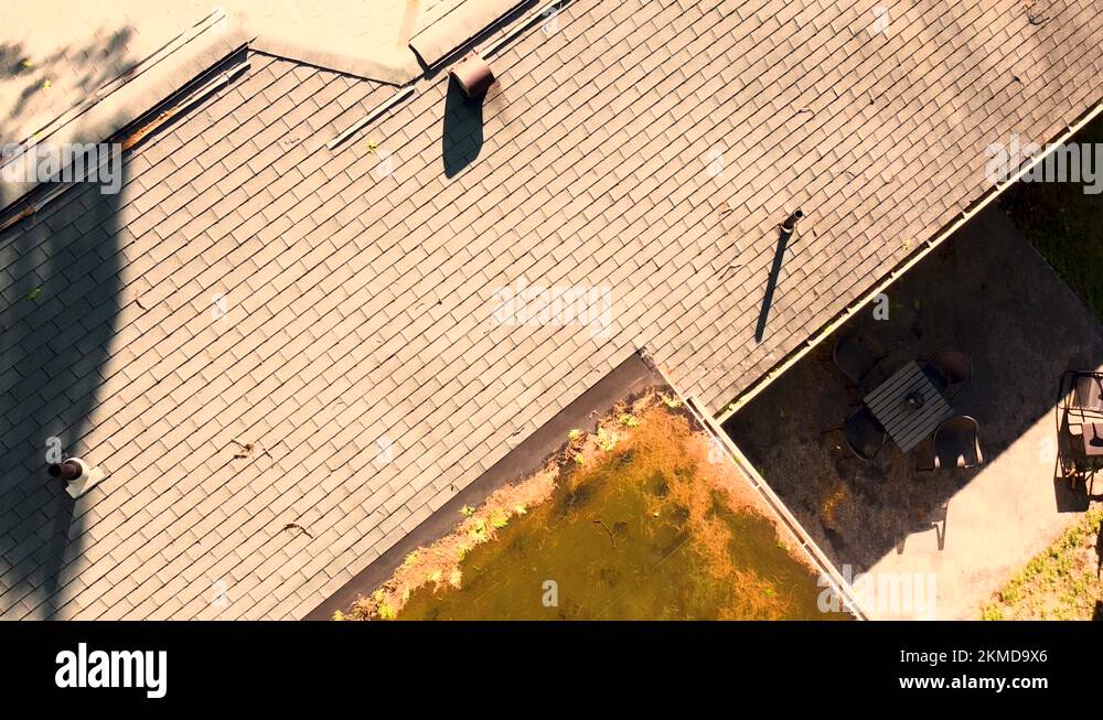 Drone showing off standing water on a flat roof home addition in Summer