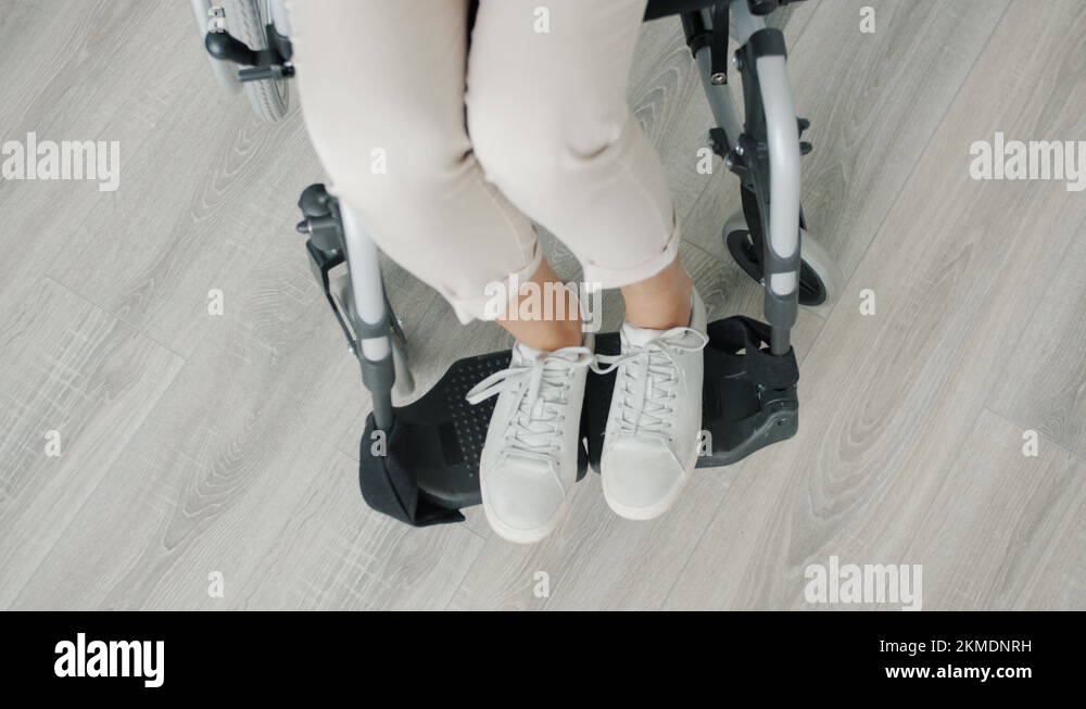 High angle view of female feet of paraplegic woman sitting in