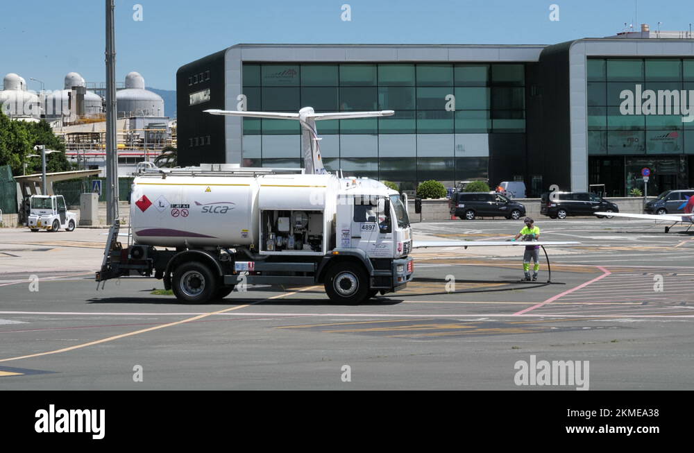 Refueler Truck With Ground Crew Refueling Wing Tank Of A Private Jet ...