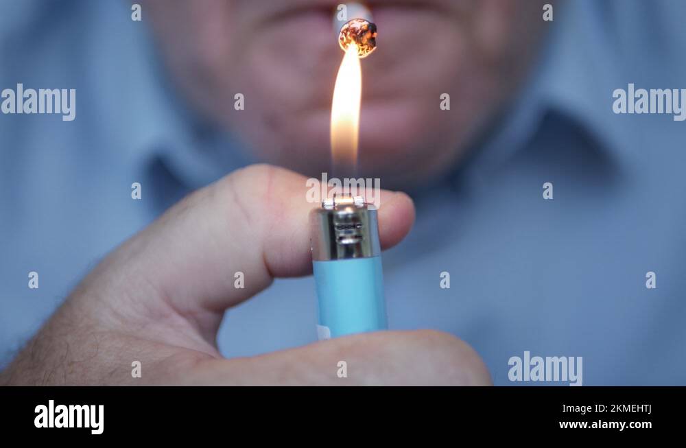 Smoker Lighting a Cigarette with a Gas Lighter. Person Smoking a