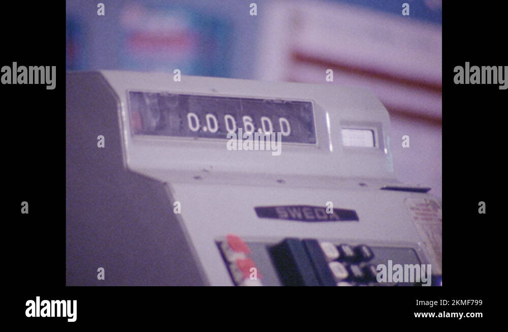 1970s Cash register amount. Cashier gives receipt to customer