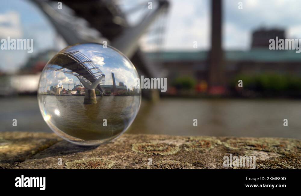 Tate Modern art gallery and the Millennium Bridge refracted in a glass ...