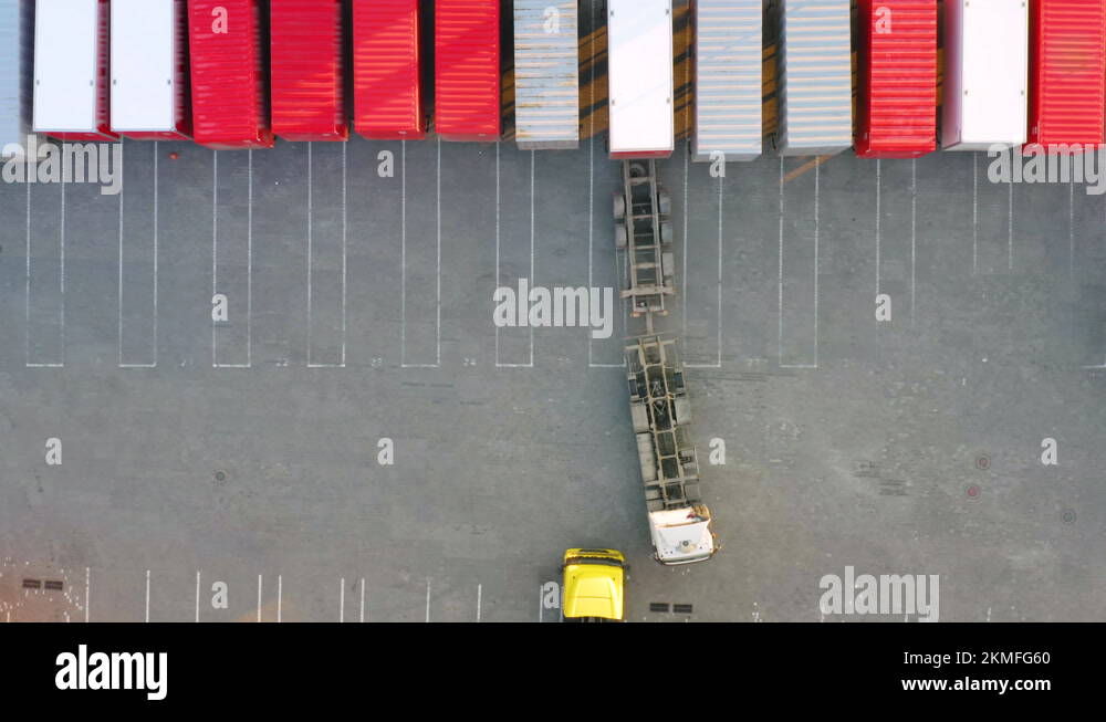 Semi-trailer is parked to the cargo container standing at warehouse ...